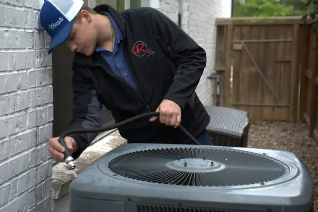 Country Air technician servicing outdoor AC condenser unit
